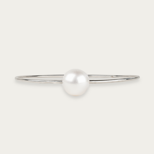 Orbit bracelet in 18k white gold with single 12mm South Sea pearl, 7cm inner diameter at widest point.