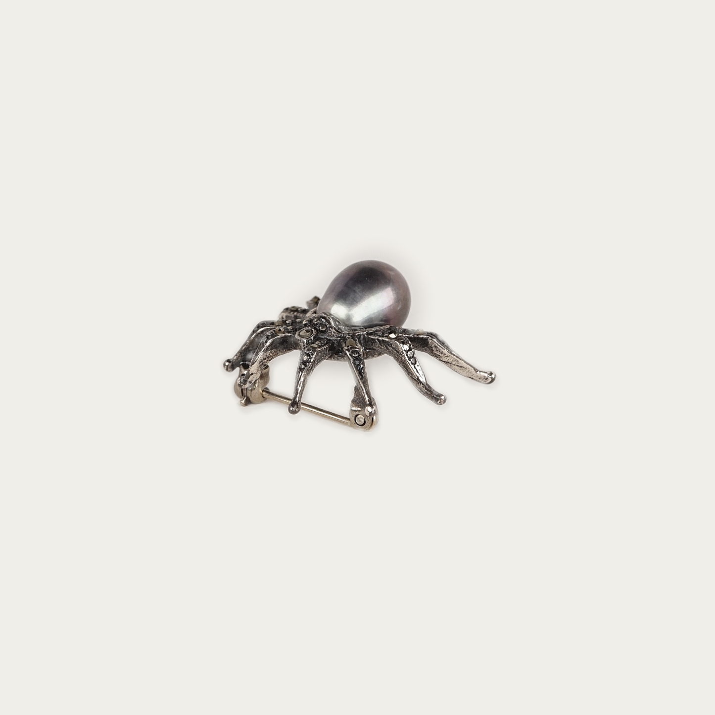 Arachne Brooch in oxidized sterling silver with marcasite stones and a 9mm dark pearl, 1.8cm by 2.5cm, traditional pin back closure.