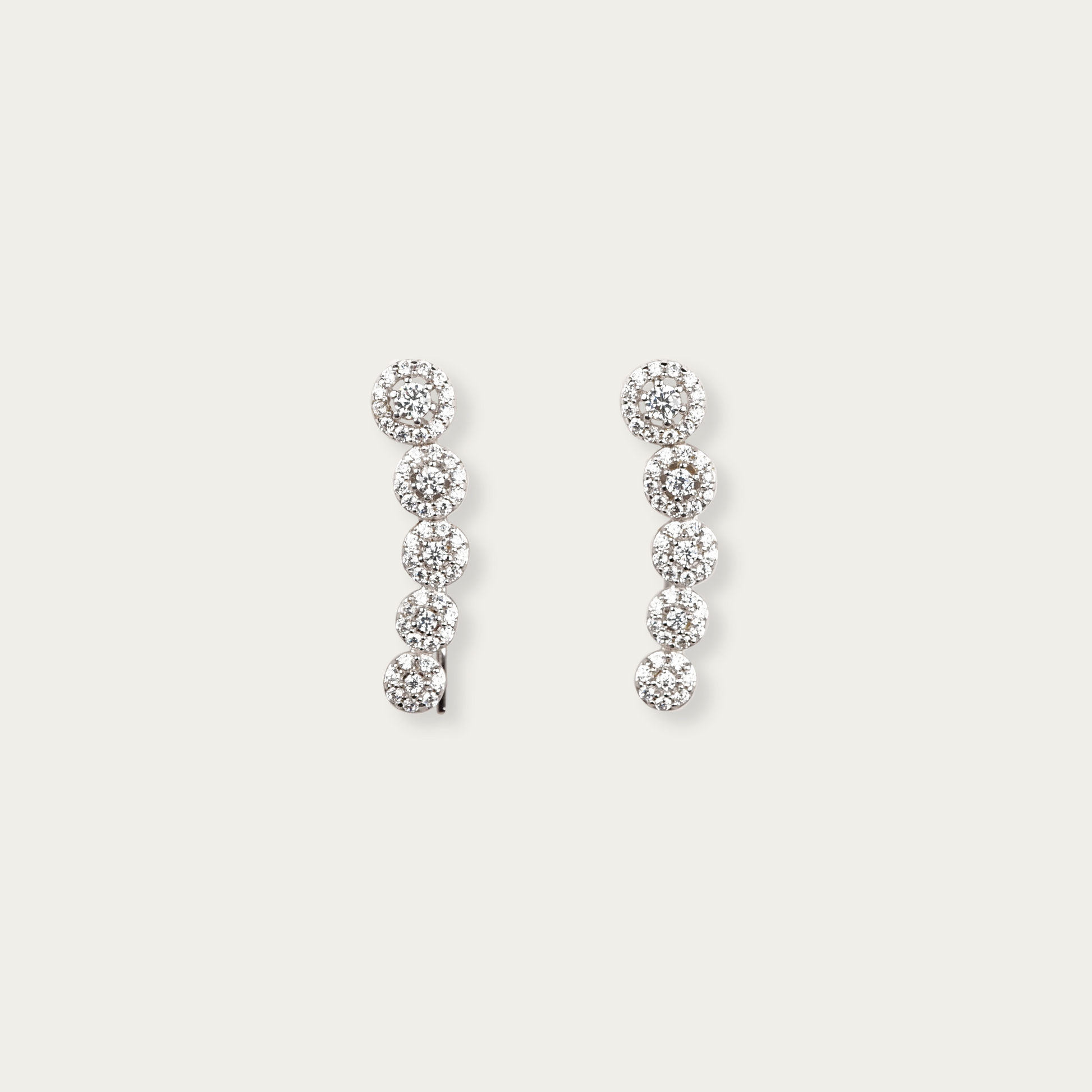 Periphery earrings in 10k white gold with descending round-cut cubic zirconia stones in halo settings, 7/8-inch length, lightweight threader-style hook, can be worn drop or climber style.