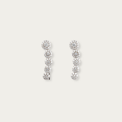 Periphery earrings in 10k white gold with descending round-cut cubic zirconia stones in halo settings, 7/8-inch length, lightweight threader-style hook, can be worn drop or climber style.