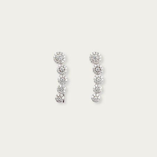 Periphery earrings in 10k white gold with descending round-cut cubic zirconia stones in halo settings, 7/8-inch length, lightweight threader-style hook, can be worn drop or climber style.
