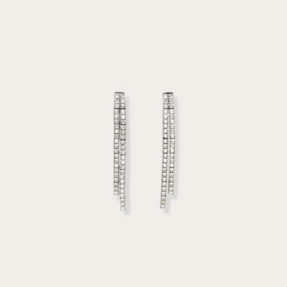 Lane Change Earrings in 18k white gold with two fine parallel lines of cubic zirconia, 1.45-inch length, linked dash segments for gentle curve and movement.