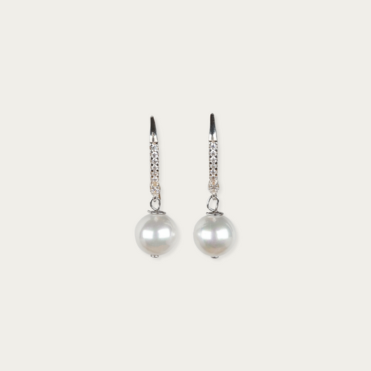 Downlight earrings in sterling silver with 10mm freshwater pearls and cubic zirconia accents, 1.25-inch drop, fish hook backings.