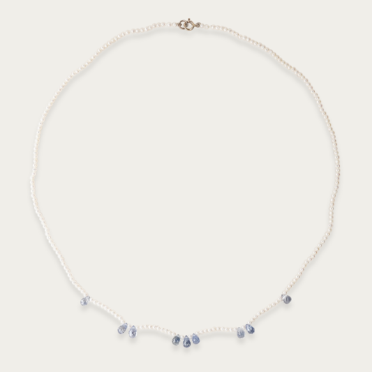 Azure Necklace with 1.5mm freshwater pearls and nine 5mm faceted blue sapphires, 16-inch length, 14k white gold spring ring clasp.