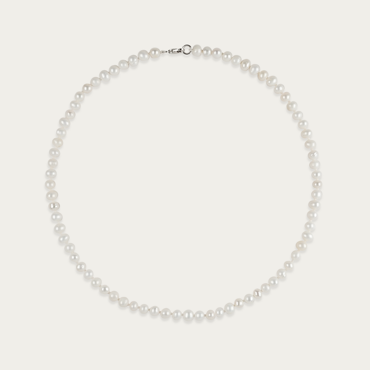 Off Label Necklace with smooth, pill-shaped freshwater pearls, 15-inch choker length, sterling silver clasp, slightly irregular by design.
