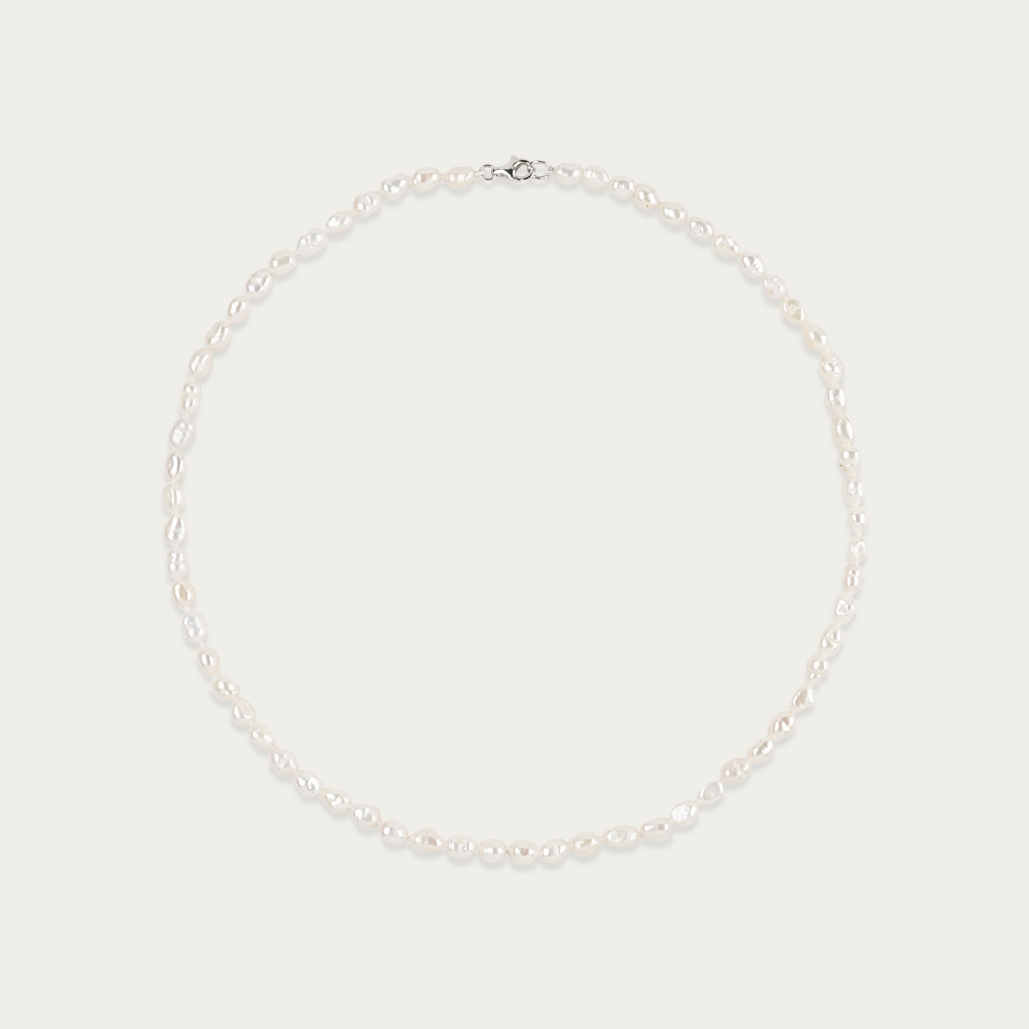 Short Grain Necklace with lustrous, rice-shaped freshwater pearls, 16-inch length, sterling silver clasp, irregular by design.
