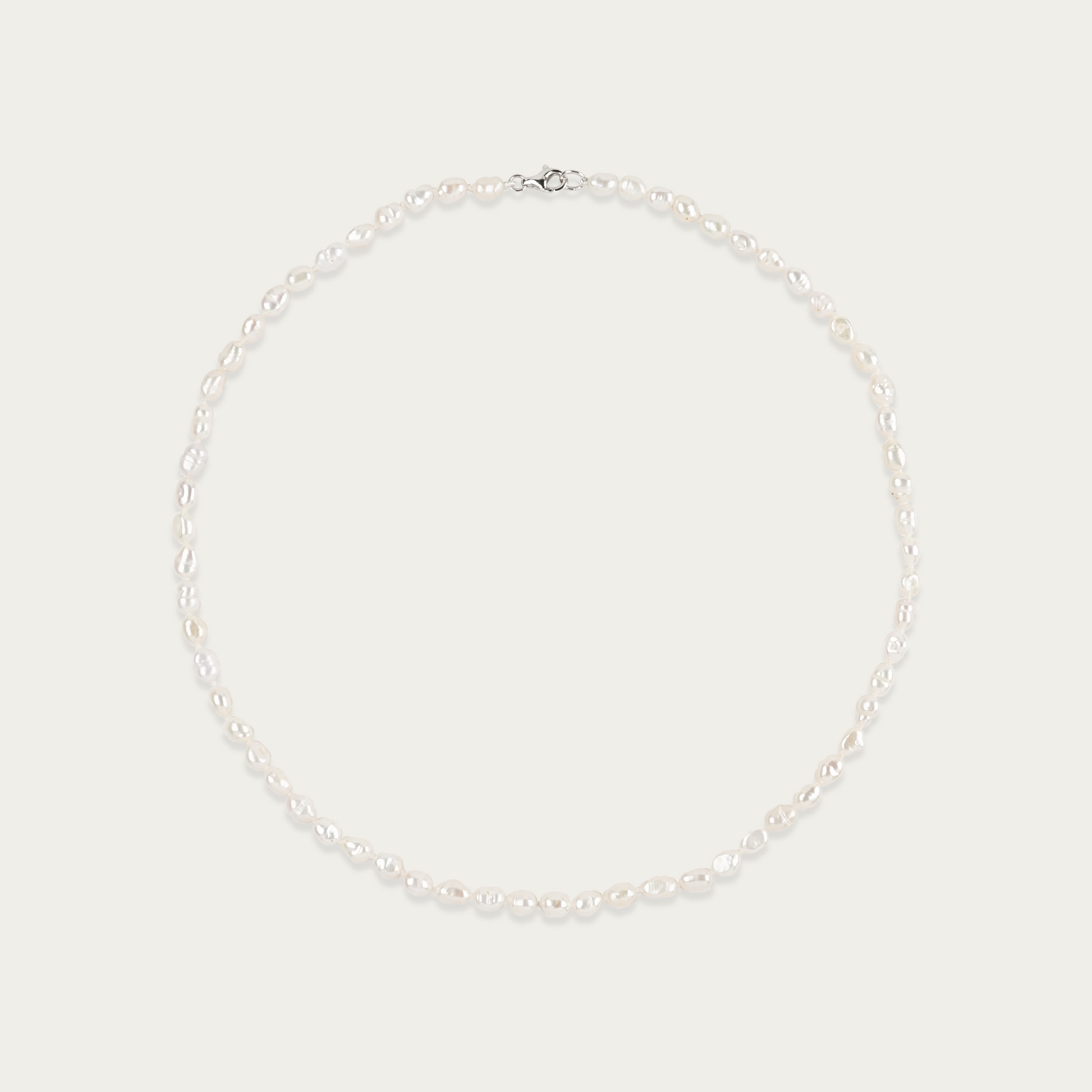 Short Grain Necklace with lustrous, rice-shaped freshwater pearls, 16-inch length, sterling silver clasp, irregular by design.