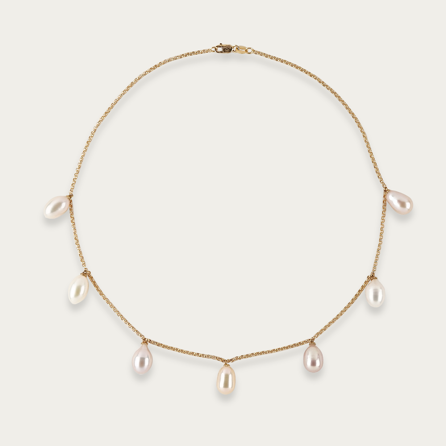 Ondine Necklace in 18k yellow gold with seven teardrop-shaped freshwater pearls, white to blush to ivory hues, 16-inch length, lobster clasp closure.