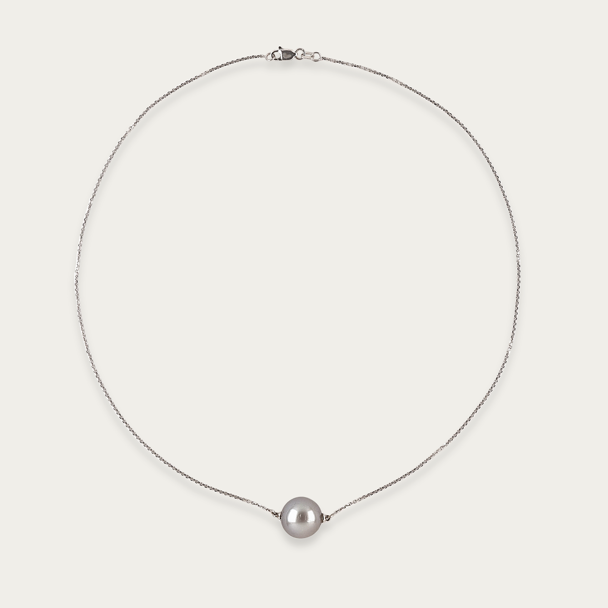 Necklace with single 11mm grey South Sea pearl on fine 18k white gold chain, 17-inch length, lobster clasp closure.
