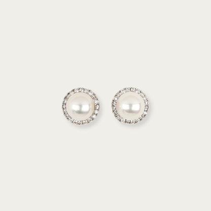 Solis Earrings in 18k white gold with 7mm cultured white pearls surrounded by a halo of diamonds, 9mm total width, post and butterfly back closure.