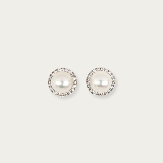 Solis Earrings in 18k white gold with 7mm cultured white pearls surrounded by a halo of diamonds, 9mm total width, post and butterfly back closure.