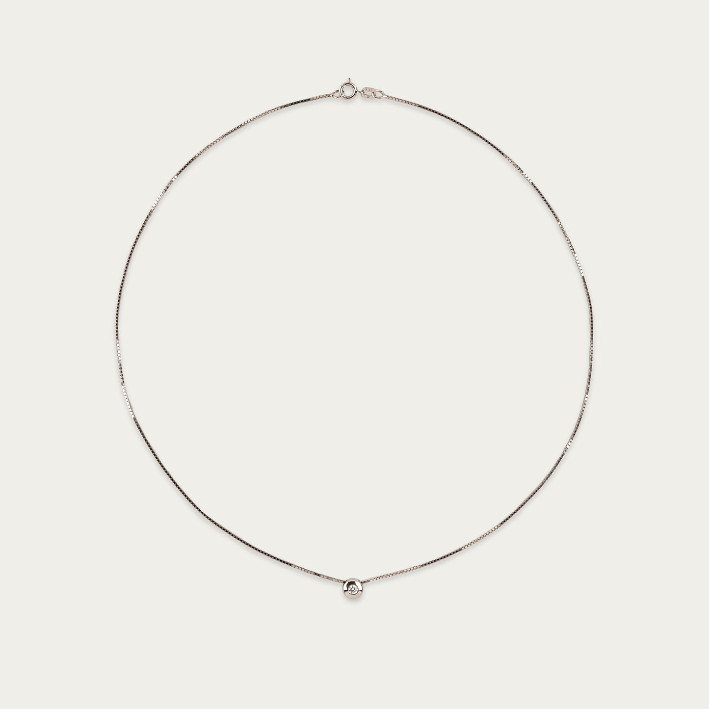 Setareh necklace in 14k white gold with a single diamond in polished 5mm bezel, sliding on 16-inch chain with spring ring clasp.