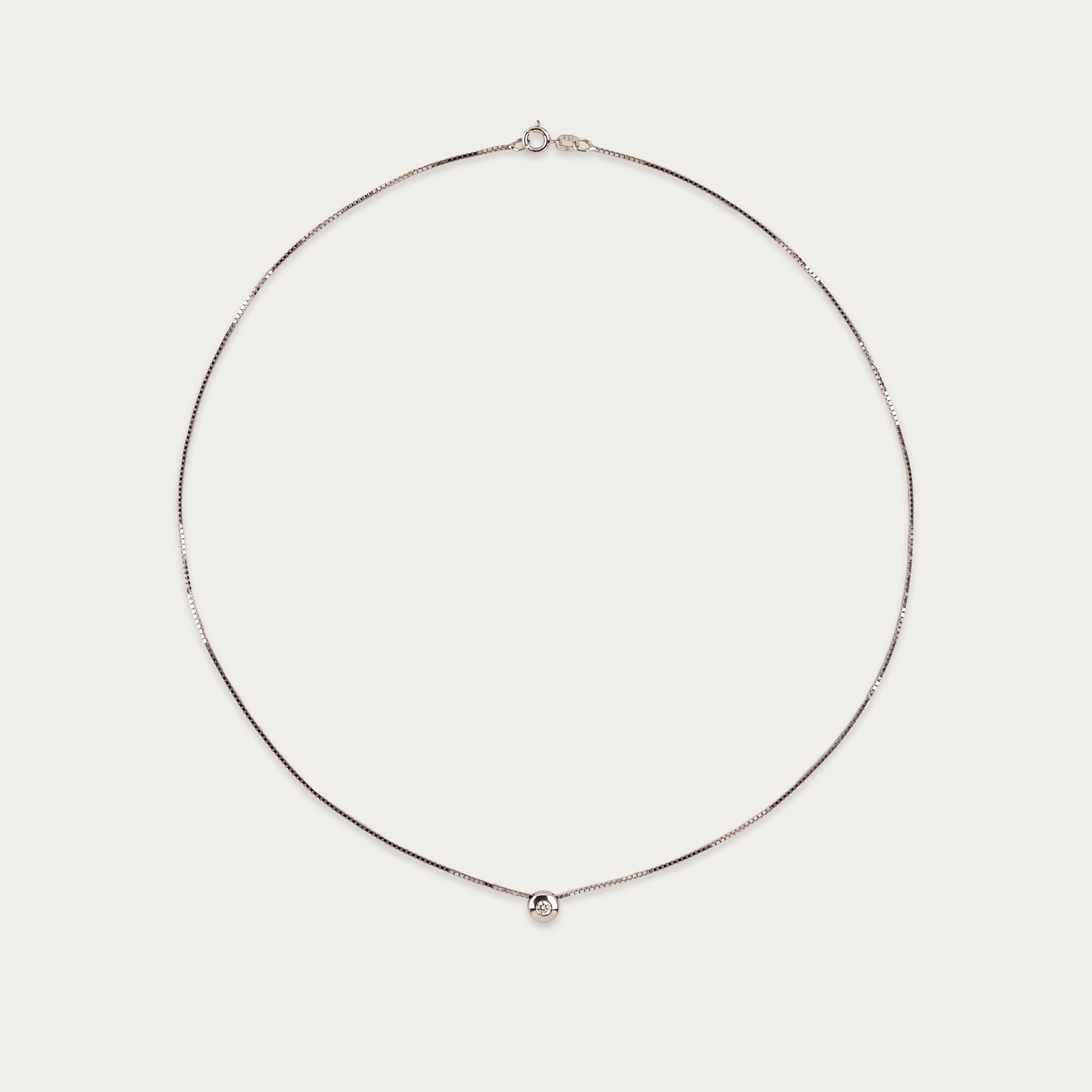 Setareh necklace in 14k white gold with a single diamond in polished 5mm bezel, sliding on 16-inch chain with spring ring clasp.