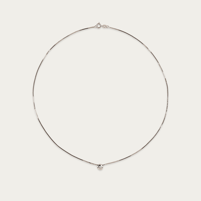 Setareh necklace in 14k white gold with a single diamond in polished 5mm bezel, sliding on 16-inch chain with spring ring clasp.