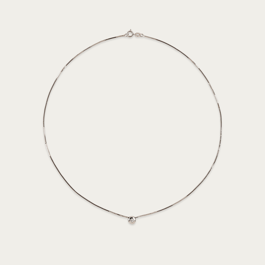 Setareh necklace in 14k white gold with a single diamond in polished 5mm bezel, sliding on 16-inch chain with spring ring clasp.