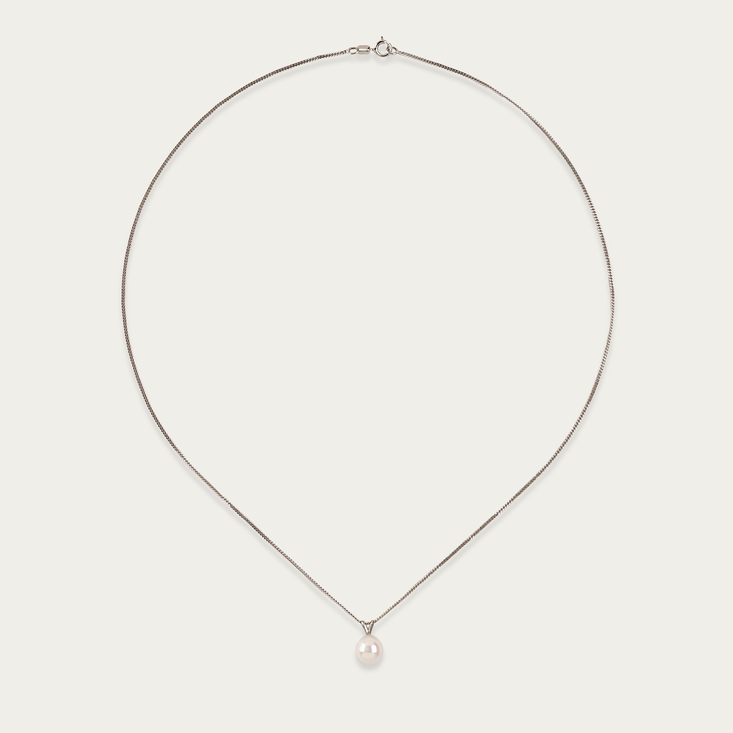 Pivot necklace with single 7mm cultured pearl suspended on 14k white gold chain, 18-inch length, spring ring clasp.