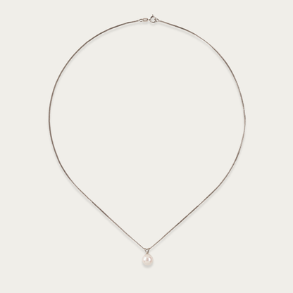 Pivot necklace with single 7mm cultured pearl suspended on 14k white gold chain, 18-inch length, spring ring clasp.