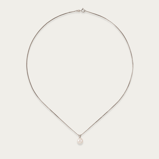 Pivot necklace with single 7mm cultured pearl suspended on 14k white gold chain, 18-inch length, spring ring clasp.