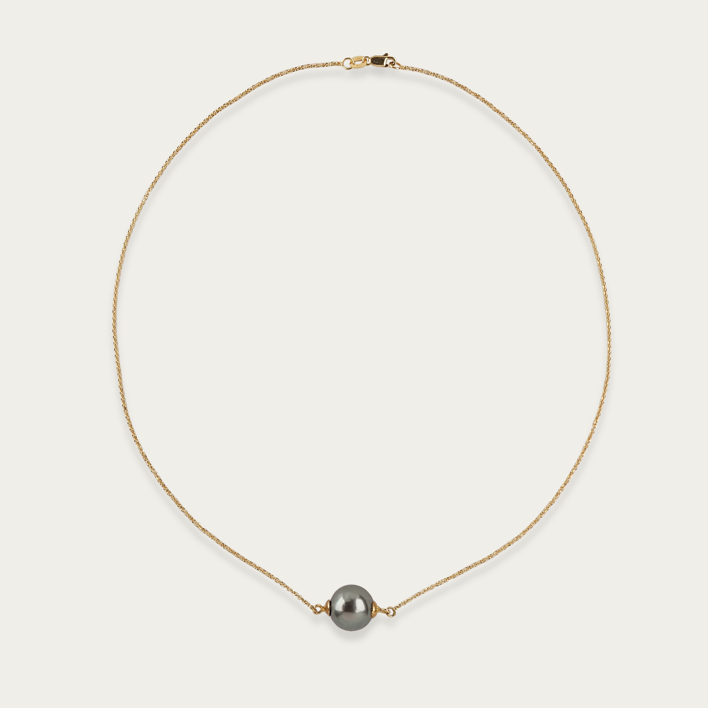 Necklace with single 11mm South Sea cultured pearl centered on 18k yellow gold chain, 16-inch length, lobster clasp closure.