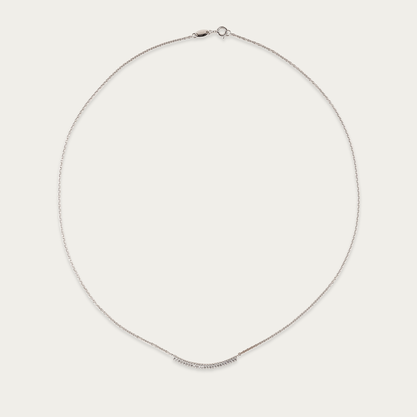 Arc Necklace in 10k white gold with curved row of cubic zirconia stones, 17-inch length, spring ring closure.