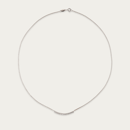 Arc Necklace in 10k white gold with curved row of cubic zirconia stones, 17-inch length, spring ring closure.