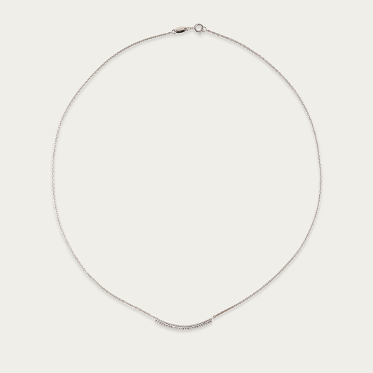 Arc Necklace in 10k white gold with curved row of cubic zirconia stones, 17-inch length, spring ring closure.